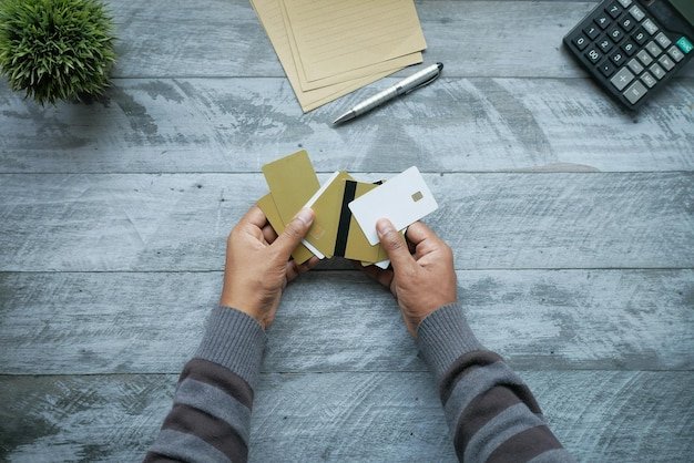 A close-up of two credit cards being held, one with a high APR crossed out and the other with a 0% APR highlighted. The image emphasizes the potential savings from transferring balances.
