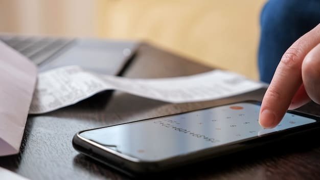 A close-up of a smartphone displaying a credit monitoring alert notification. The background is blurred, suggesting an on-the-go setting.