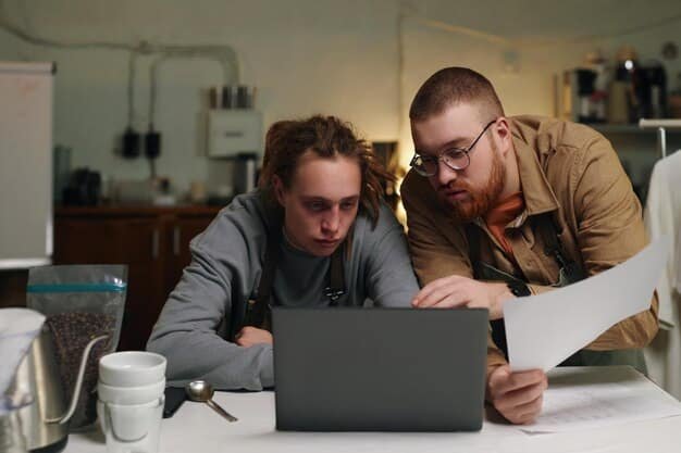 Two people sitting at a table discussing finances, with paperwork and a laptop showing credit reports. The atmosphere is collaborative and focused.